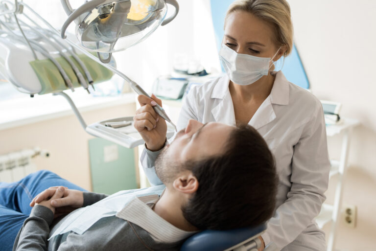 young female dentist treating patient 9w8rygl